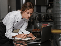 This photo depicts the administrative and managerial side of running a food business, which is a crucial aspect for entrepreneurs using a culinary incubator.