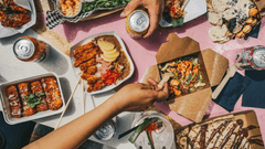 The image provided is a vibrant, top-down view (flat lay) of a social gathering centered around diverse street food.