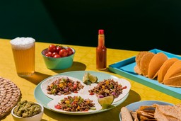 A photograph of a round platter with Mexican food.