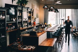 Modern steakhouse restaurant with a bar and elegant tables