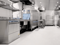 Modern stainless steel kitchen setup with ample space, ideal for guides on how to secure a commercial kitchen lease.