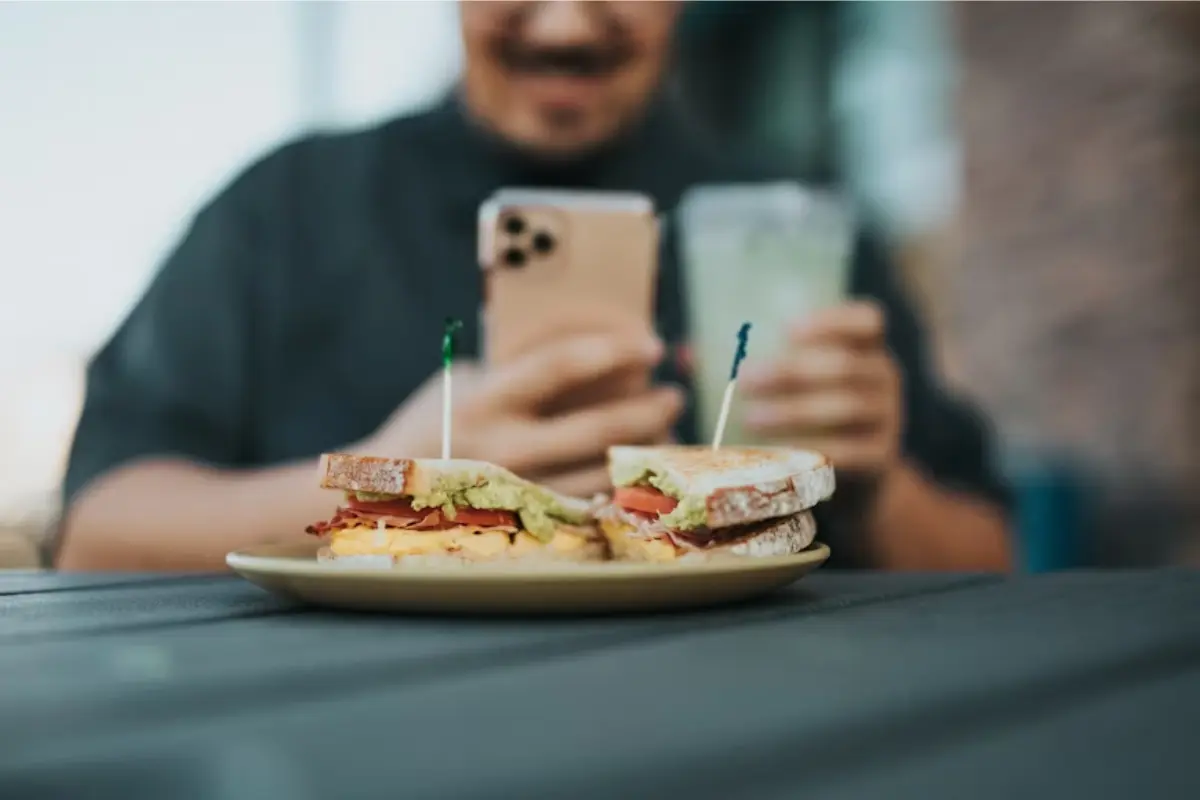 This image perfectly captures the power of visual marketing and user-generated content. It emphasizes the importance of presentation, ambiance, and digital engagement in promoting a food business.