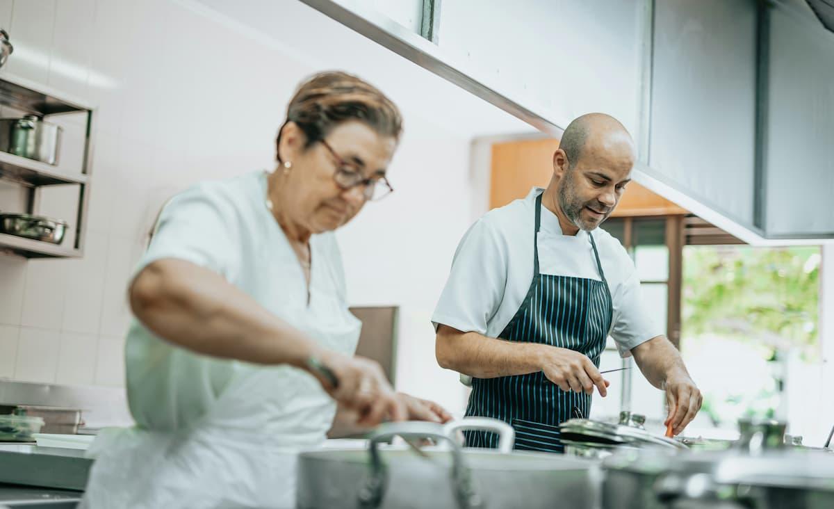 Chefs cooking healthy meals in a modern kitchen, representing ghost kitchens and wellness food trends.
