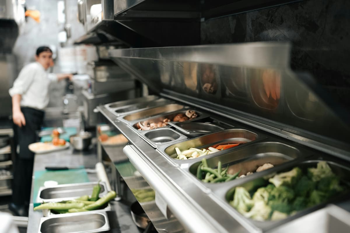 Industrial kitchen setup with fresh ingredients, illustrating how to boost restaurant production for large scale events.