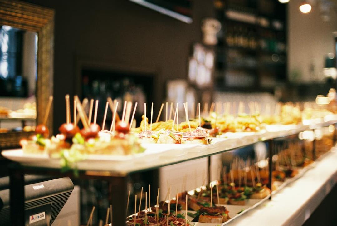 Colorful catering display with assorted appetizers on skewers, showing strategies to handle high volume catering orders efficiently.